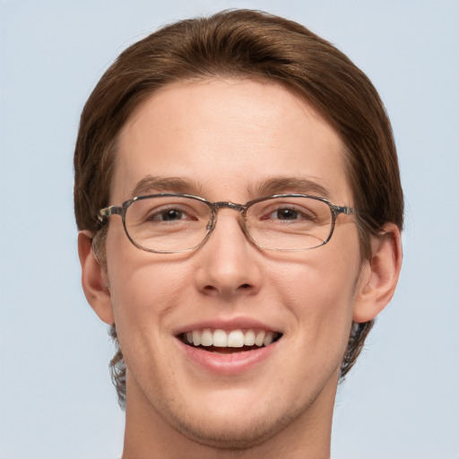 Joyful white adult male with short  brown hair and green eyes