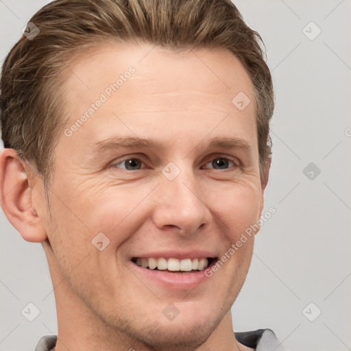 Joyful white adult male with short  brown hair and grey eyes