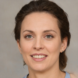 Joyful white adult female with medium  brown hair and brown eyes