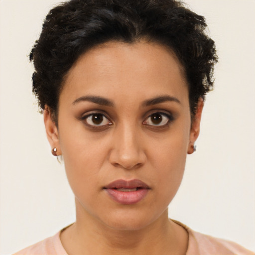 Joyful latino young-adult female with short  brown hair and brown eyes