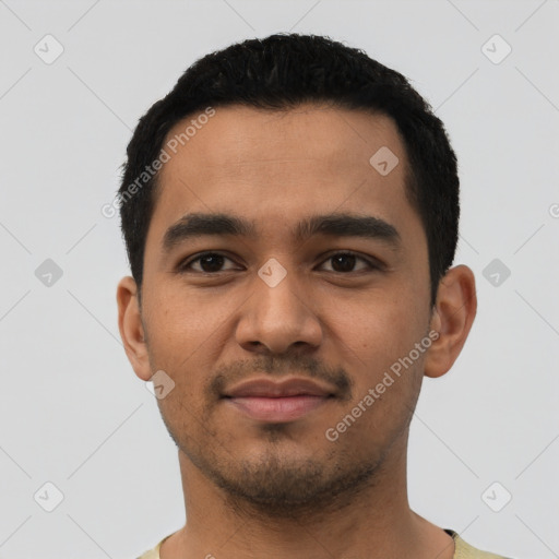 Joyful latino young-adult male with short  black hair and brown eyes