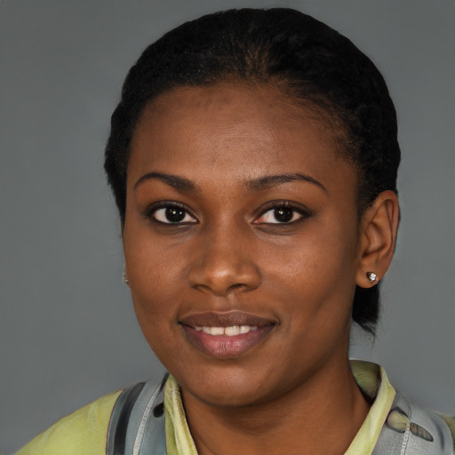 Joyful black young-adult female with short  black hair and brown eyes