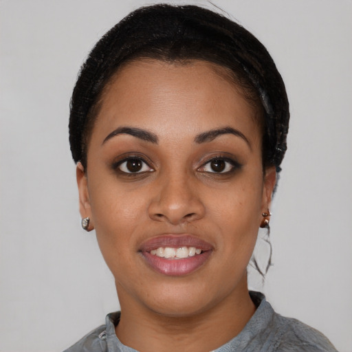 Joyful black young-adult female with short  black hair and brown eyes