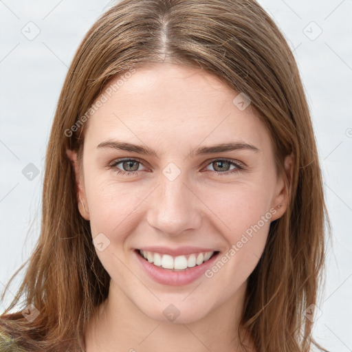 Joyful white young-adult female with long  brown hair and green eyes