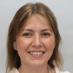 Joyful white adult female with medium  brown hair and brown eyes