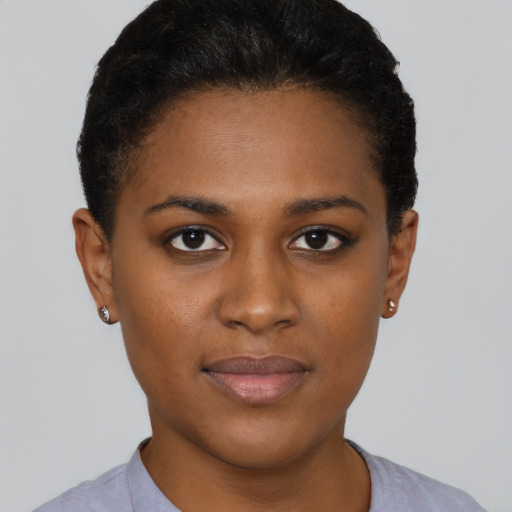 Joyful black young-adult female with short  brown hair and brown eyes