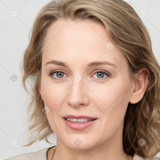 Joyful white young-adult female with medium  brown hair and blue eyes