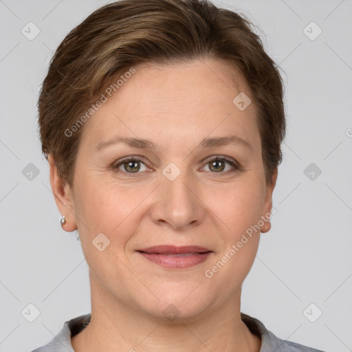 Joyful white adult female with short  brown hair and grey eyes