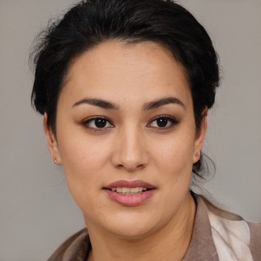 Joyful latino young-adult female with medium  brown hair and brown eyes