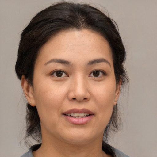 Joyful asian young-adult female with medium  brown hair and brown eyes