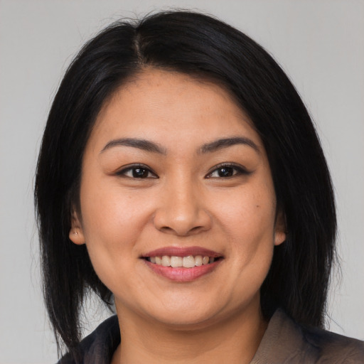 Joyful asian young-adult female with long  black hair and brown eyes