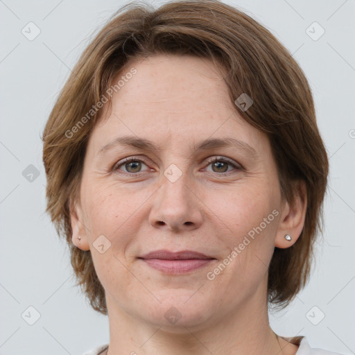 Joyful white adult female with medium  brown hair and grey eyes