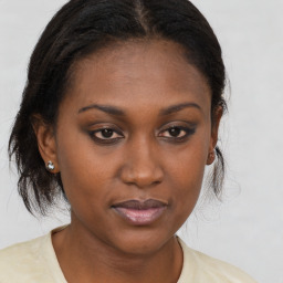 Joyful black young-adult female with medium  brown hair and brown eyes