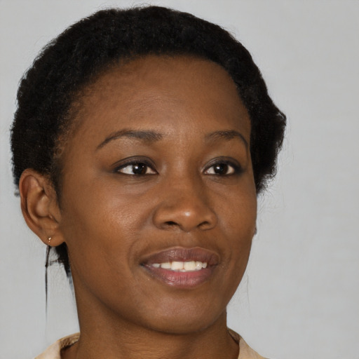 Joyful black young-adult female with short  brown hair and brown eyes