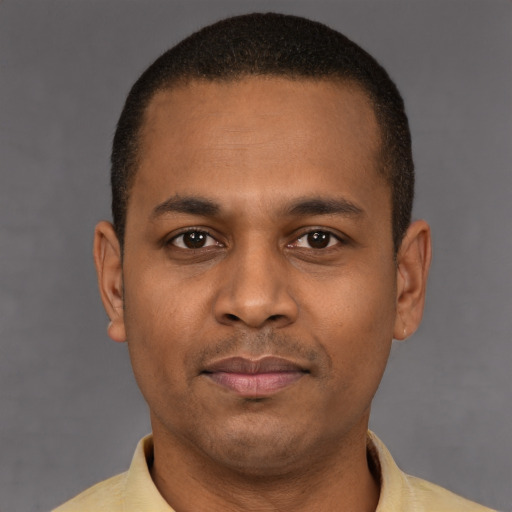 Joyful latino young-adult male with short  brown hair and brown eyes