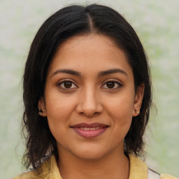 Joyful latino young-adult female with medium  brown hair and brown eyes