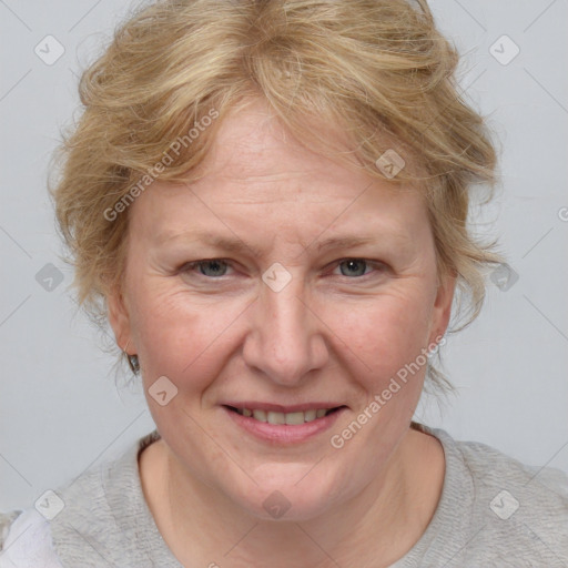 Joyful white adult female with medium  brown hair and blue eyes