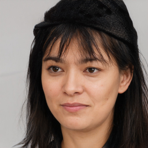 Joyful asian young-adult female with long  brown hair and brown eyes