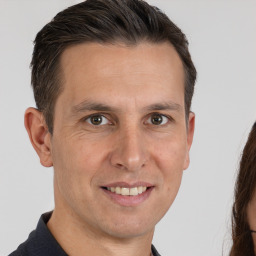 Joyful white adult male with short  brown hair and brown eyes