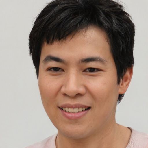 Joyful asian young-adult male with short  brown hair and brown eyes