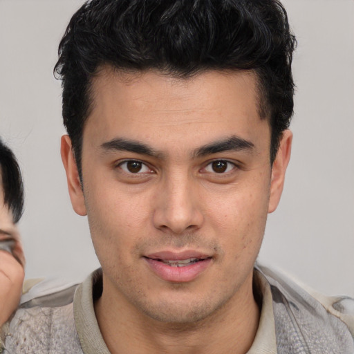 Joyful latino young-adult male with short  brown hair and brown eyes