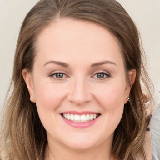 Joyful white young-adult female with long  brown hair and grey eyes