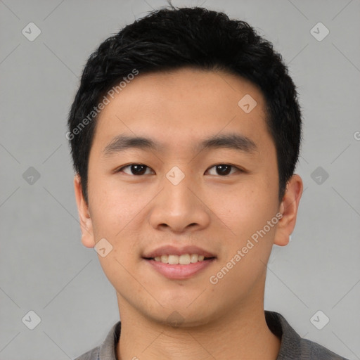 Joyful asian young-adult male with short  black hair and brown eyes