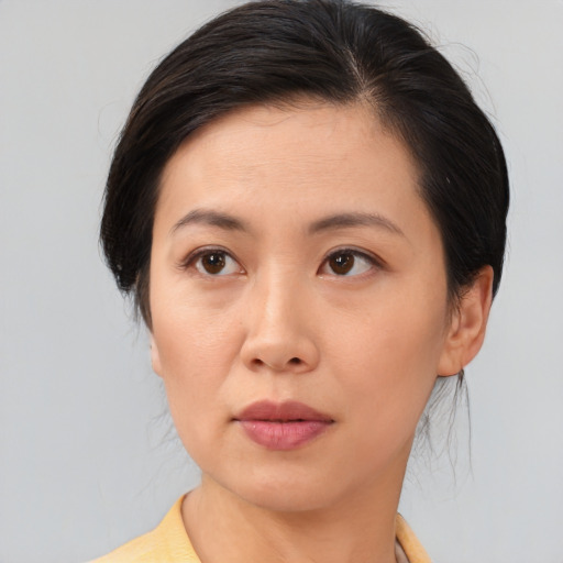 Joyful asian young-adult female with medium  brown hair and brown eyes