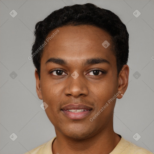 Joyful black young-adult male with short  black hair and brown eyes