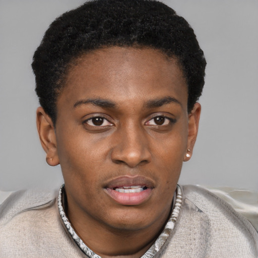 Joyful black young-adult male with short  black hair and brown eyes