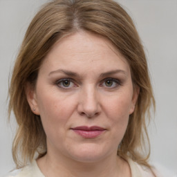 Joyful white adult female with medium  brown hair and grey eyes