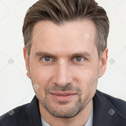 Joyful white adult male with short  brown hair and brown eyes