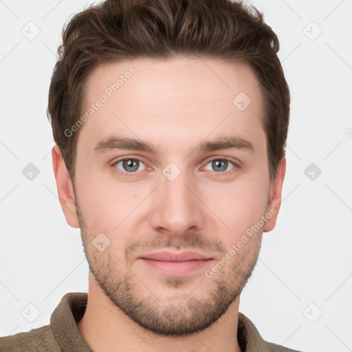 Joyful white young-adult male with short  brown hair and grey eyes