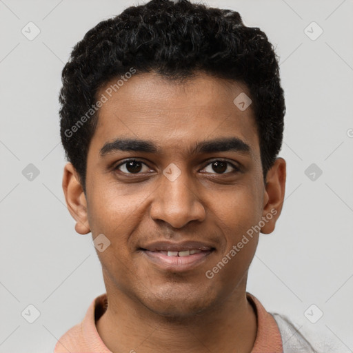 Joyful black young-adult male with short  black hair and brown eyes