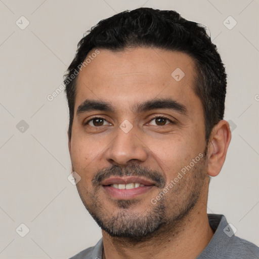 Joyful white young-adult male with short  black hair and brown eyes