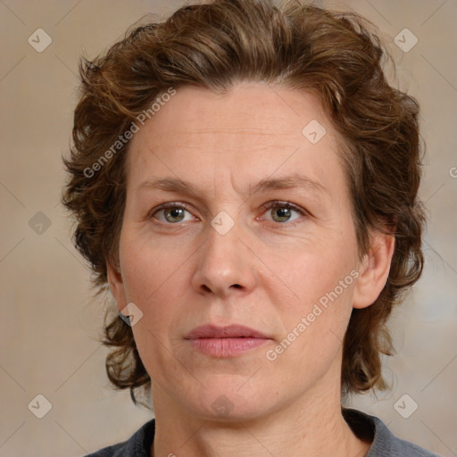 Joyful white adult female with medium  brown hair and blue eyes