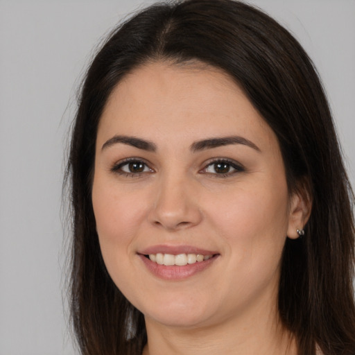 Joyful white young-adult female with long  brown hair and brown eyes