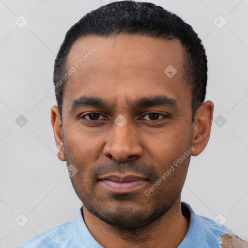 Neutral latino young-adult male with short  black hair and brown eyes