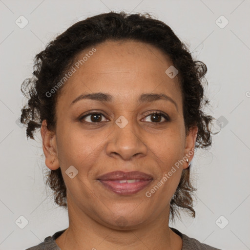 Joyful latino adult female with medium  brown hair and brown eyes