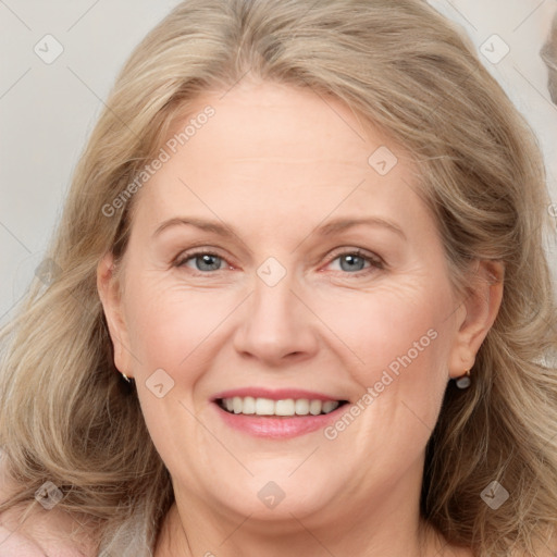 Joyful white adult female with medium  brown hair and blue eyes