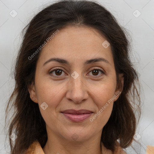 Joyful white adult female with long  brown hair and brown eyes