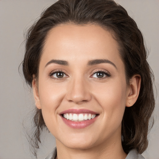 Joyful white young-adult female with medium  brown hair and brown eyes