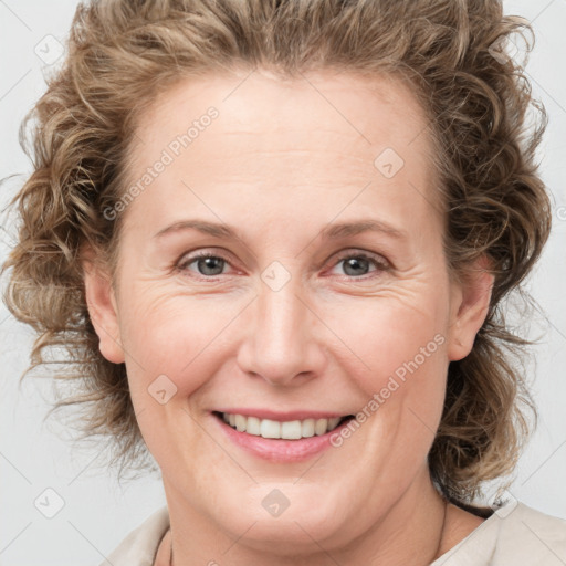 Joyful white young-adult female with medium  brown hair and blue eyes