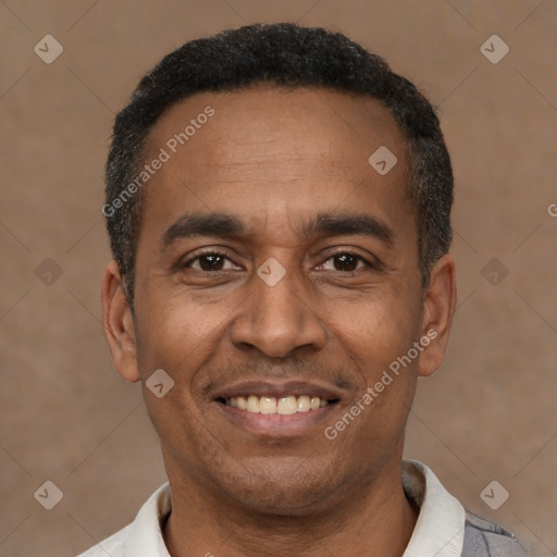 Joyful latino adult male with short  black hair and brown eyes