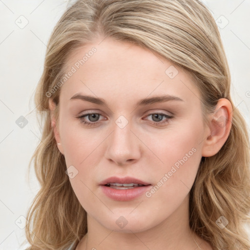 Joyful white young-adult female with long  brown hair and blue eyes