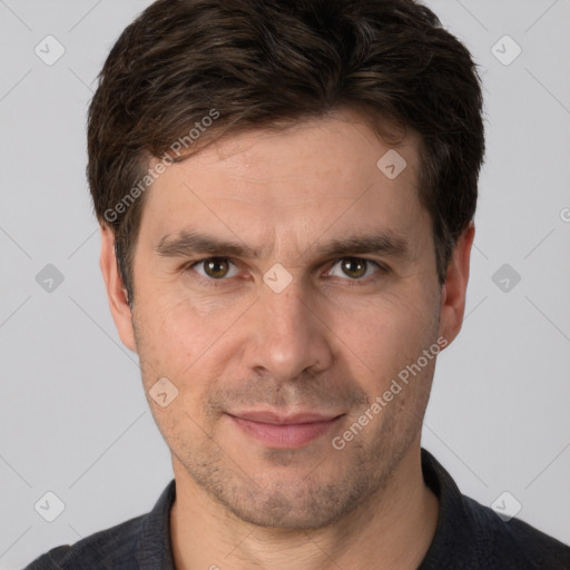 Joyful white adult male with short  brown hair and brown eyes