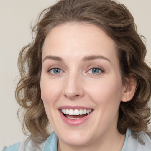 Joyful white young-adult female with medium  brown hair and blue eyes