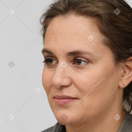 Joyful white adult female with medium  brown hair and brown eyes