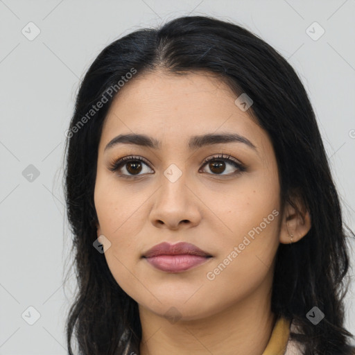 Joyful latino young-adult female with long  black hair and brown eyes