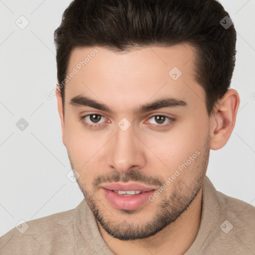 Joyful white young-adult male with short  brown hair and brown eyes